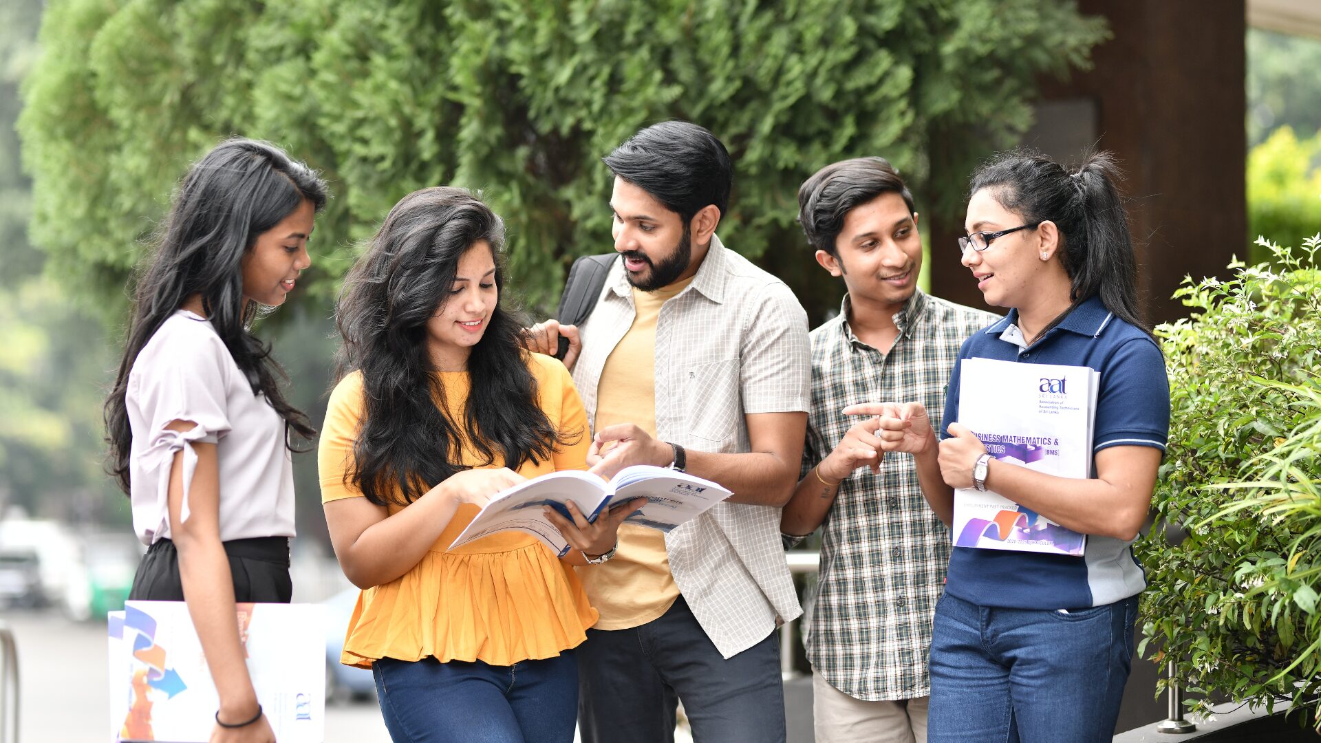 A group of people talking together, representing community and Telugu language usage to create belongingness among adults