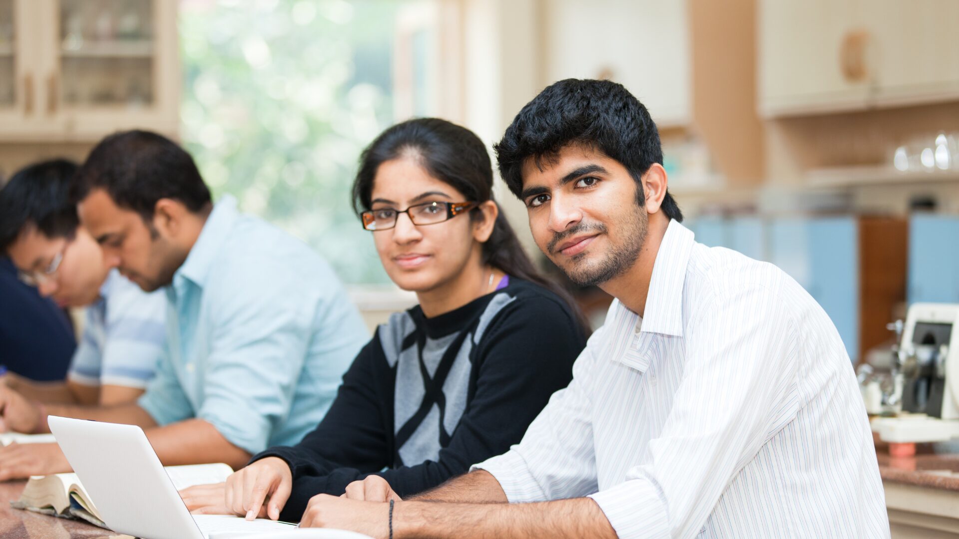 “South Asian teenagers sitting together, smiling and connected — representing diaspora Telugu teens navigating identity and language.
